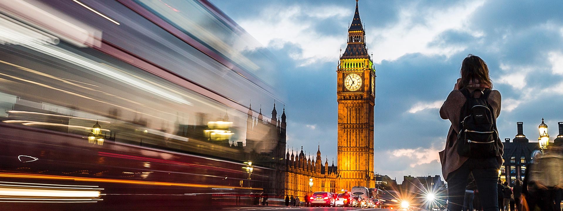 Woman taking a photo of Big Ben clocktower in London