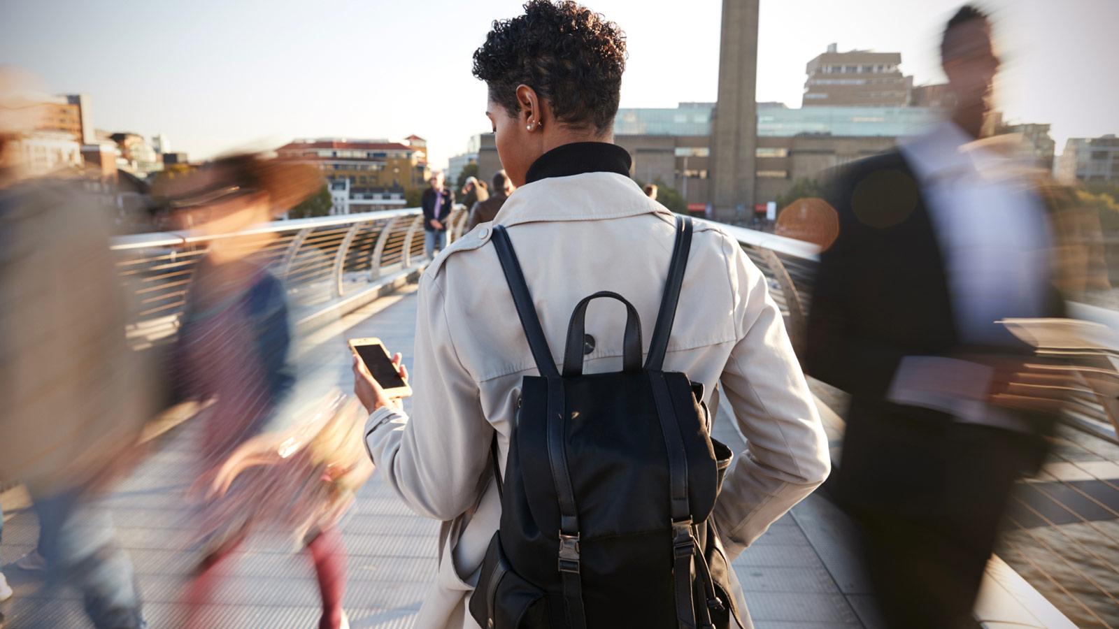 woman walking and looking at her mobile