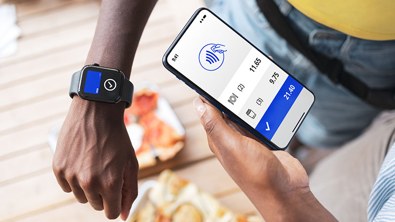 Contactless payment being made with watch and phone