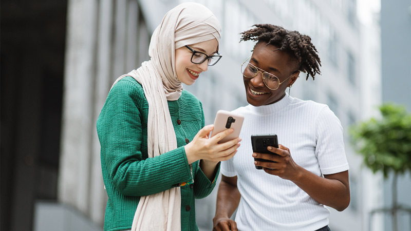 Woman showing something on her smartphone to female colleague