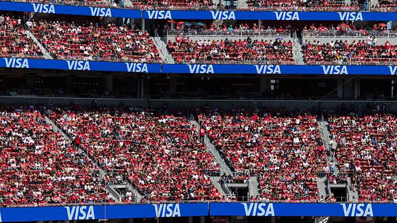 Visa logo on digital screens at pro football stadium