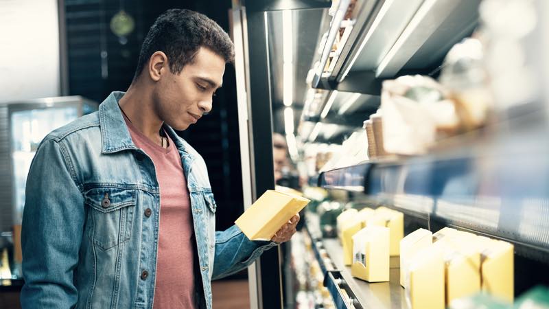 Man checking out a product in a grocery store.